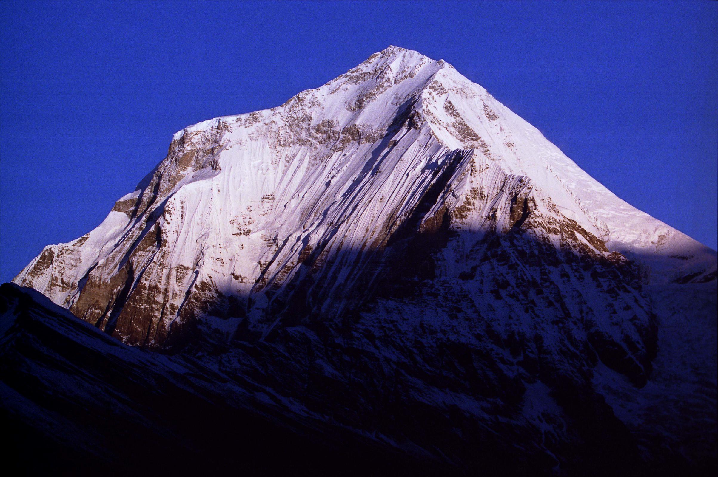 203 Dhaulagiri Sunrise From Shepherds Kharka The sun slowly came down Dhaulagiri and Tukuche Peak at sunrise from Shepherds Kharka (3760m) on the way to Annapurna North Base Camp, changing quickly from yellow to bright white.